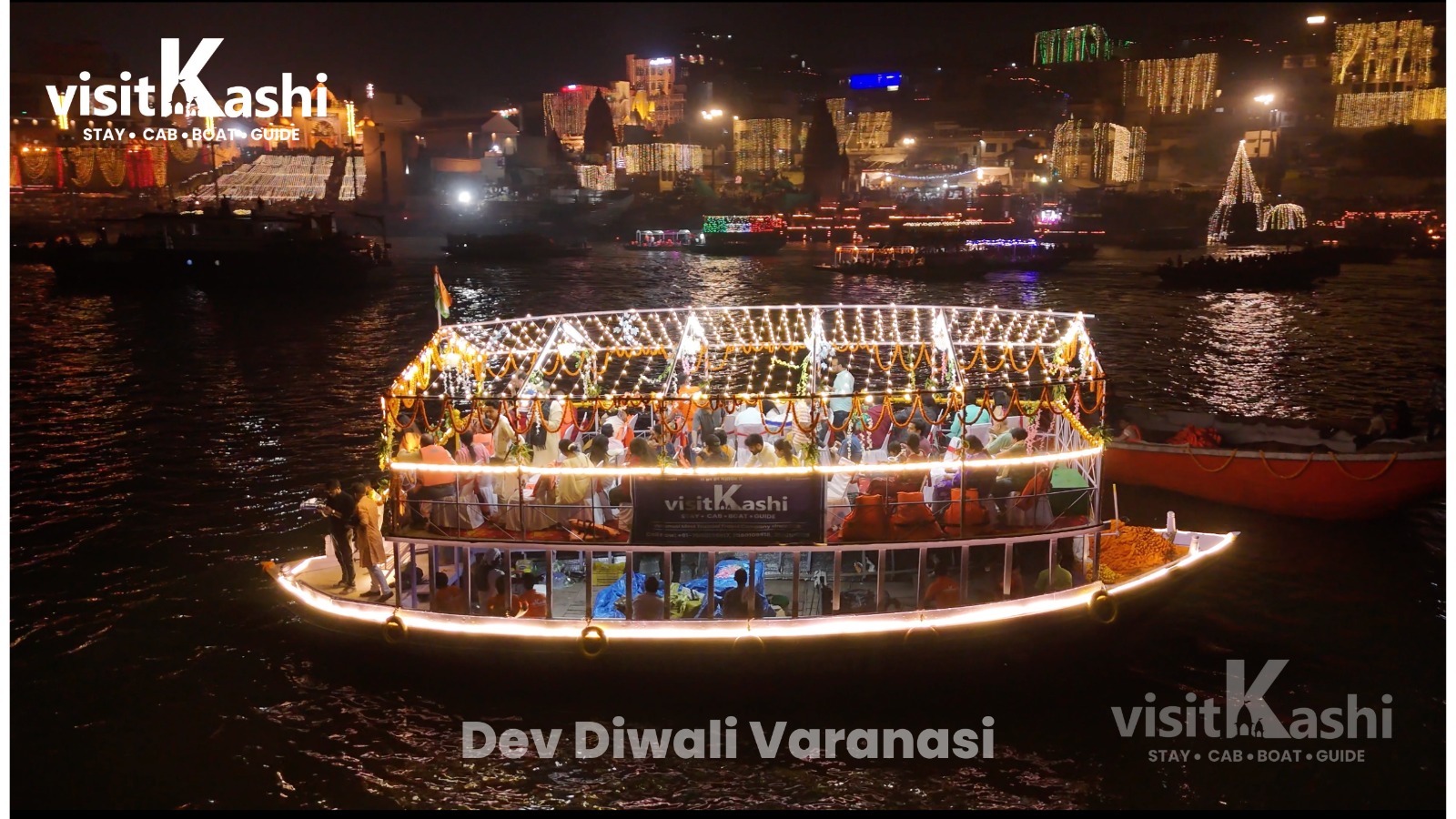 Decorated Dev Diwali boat beside illuminated Varanasi ghats