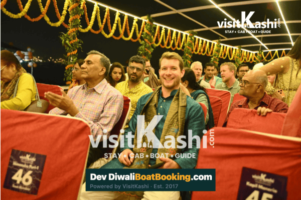 Guests seated under festive lights on a Dev Deepawali cruise in Varanasi